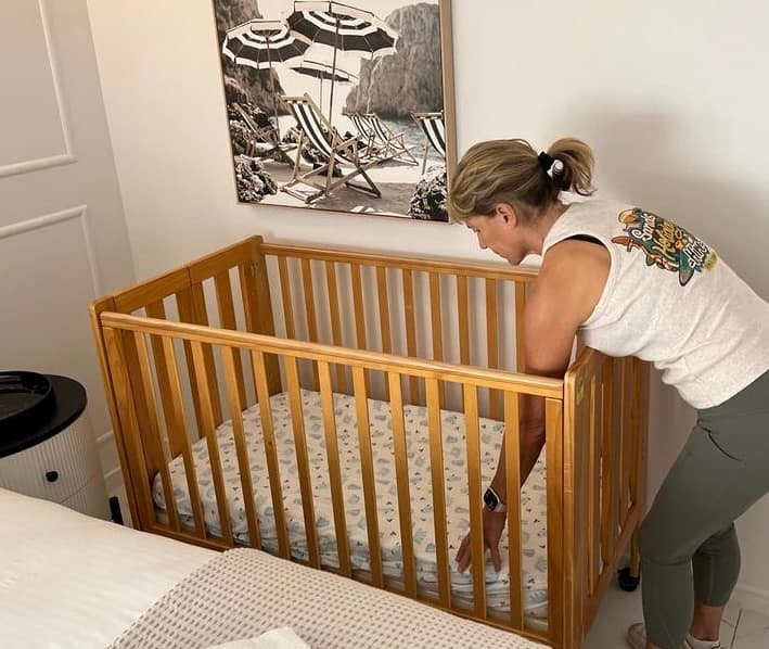 An EMU team member preparing a cot for a holiday stay